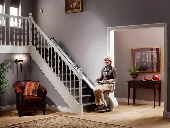woman sitting on Access BDD HomeGlide Standard Straight Stairlift