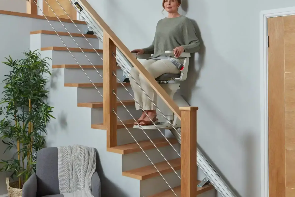 woman sitting on the Ergo Straight Stairlift seat rental