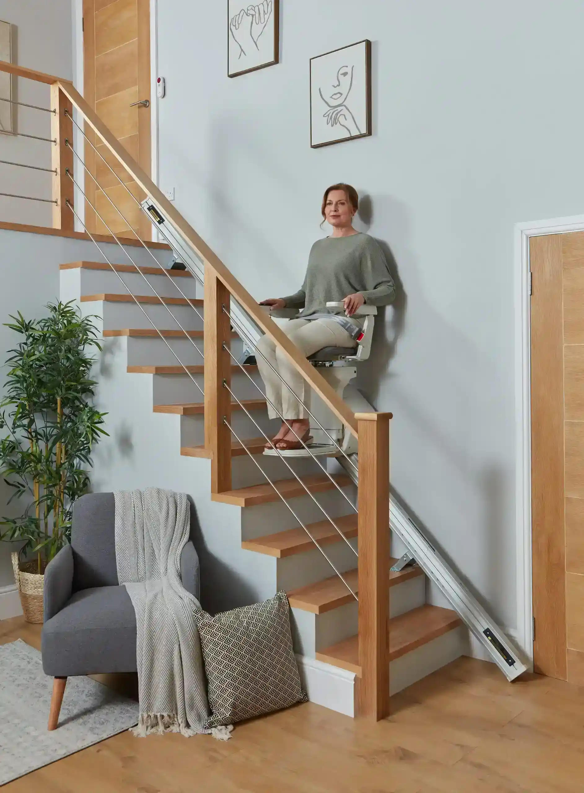 woman sitting on the Ergo Straight Stairlift seat rental