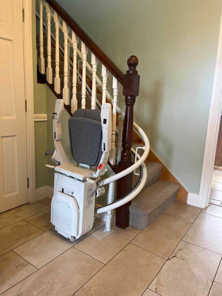 Curved stairlift parked at the foot of the stairs in a Kilbeggan home