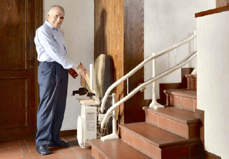Elderly man folding the Platinum curved stairlift seat