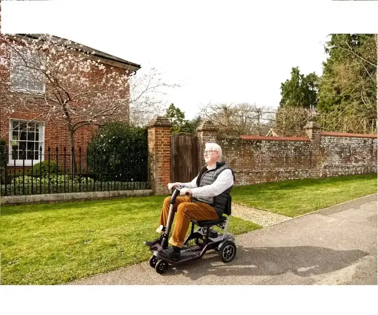 elderly man using qfold mobility scooter