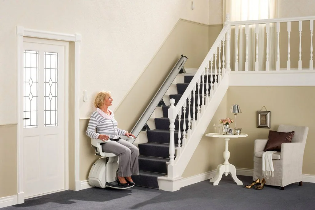 woman on stairlift to improve mobility in home