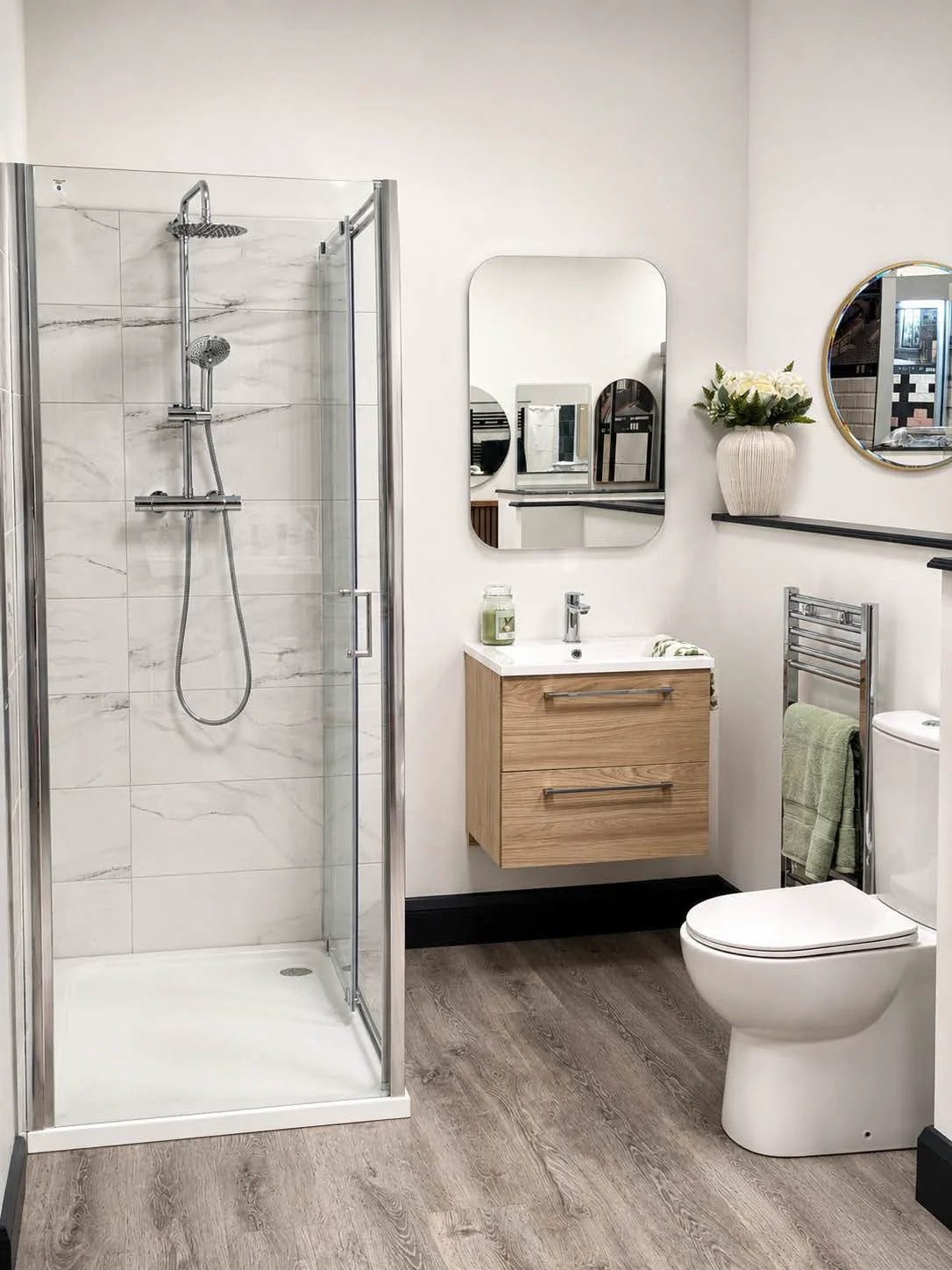 Marble-tiled shower enclosure with chrome rainfall shower at The Shower Room Collection showroom in Clane