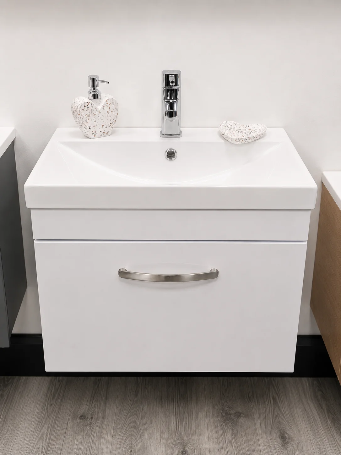 White wall-hung vanity unit with chrome basin tap