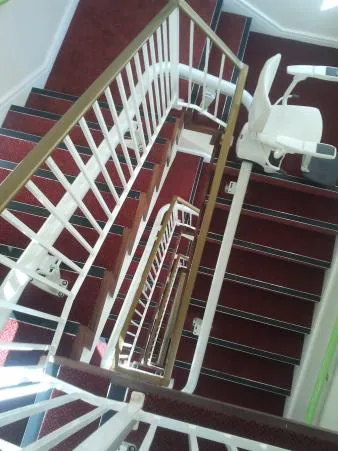 Flow X stairlift rail running up several flights of stairs