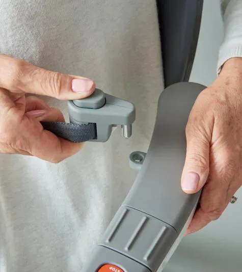 Hand fastening the Flow X stairlift seatbelt into its buckle