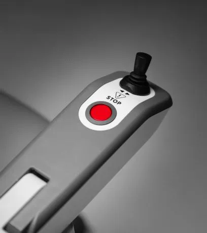 Red emergency stop button and joystick on the HomeGlide armrest